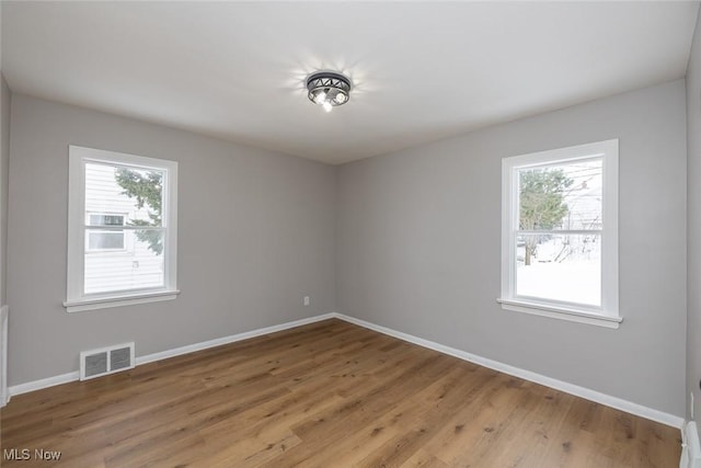 unfurnished room featuring light hardwood / wood-style floors