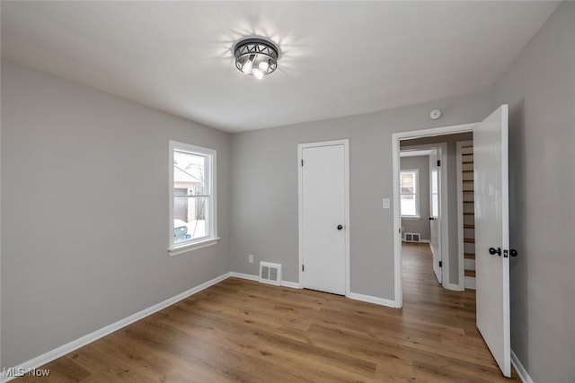 unfurnished bedroom featuring hardwood / wood-style floors