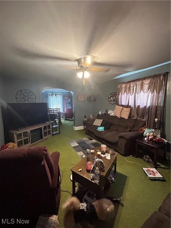 living room with ceiling fan and carpet flooring