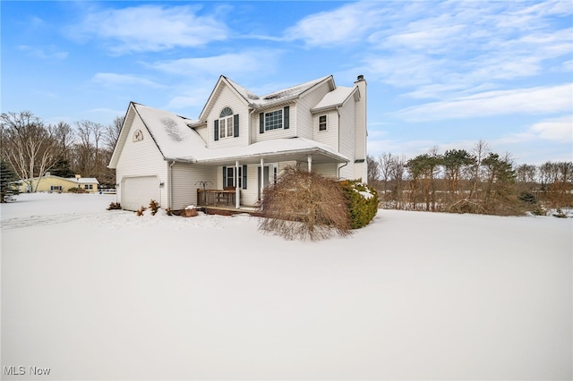 view of property featuring a garage and covered porch