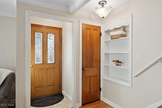 foyer entrance with beamed ceiling