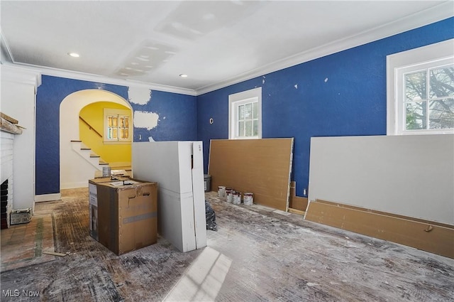 interior space featuring ornamental molding and a brick fireplace