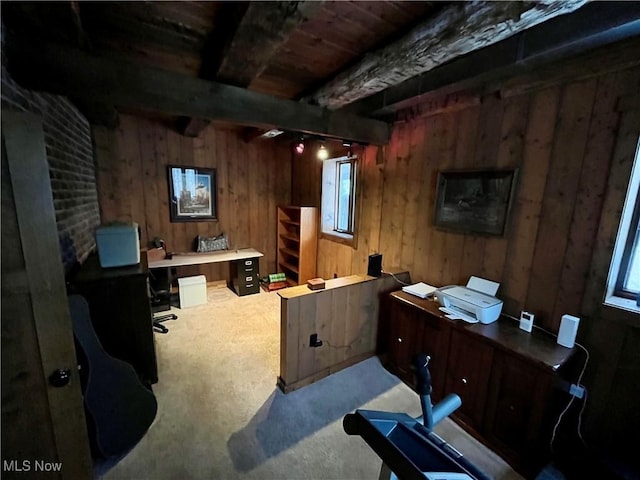 carpeted office featuring beamed ceiling and wood walls