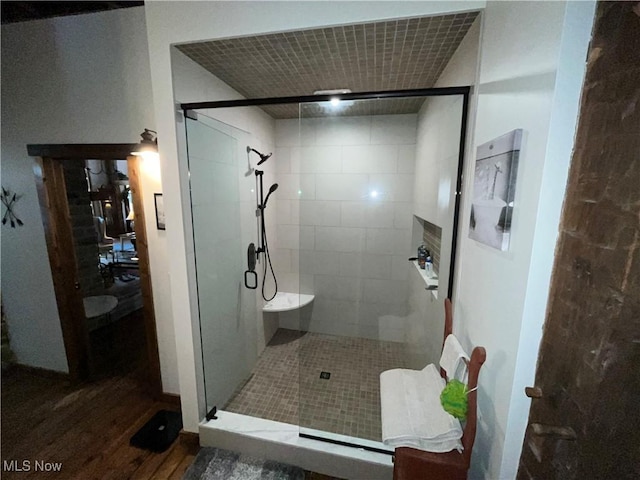 bathroom featuring wood-type flooring and walk in shower