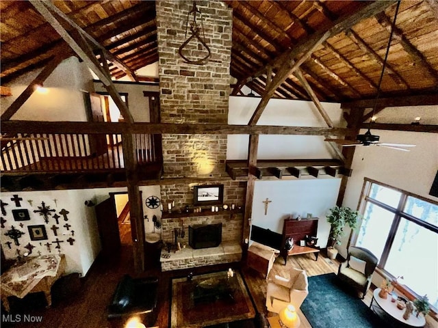 unfurnished living room with high vaulted ceiling and beamed ceiling