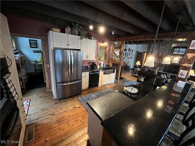 kitchen with sink, white cabinetry, stainless steel refrigerator, dishwasher, and light hardwood / wood-style floors