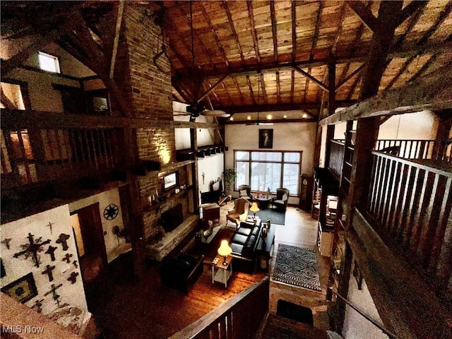 interior space with beam ceiling, hardwood / wood-style flooring, and high vaulted ceiling