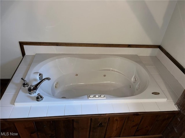 bathroom with a relaxing tiled tub