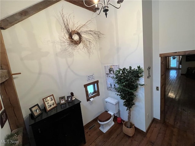 bathroom featuring wood-type flooring and a chandelier