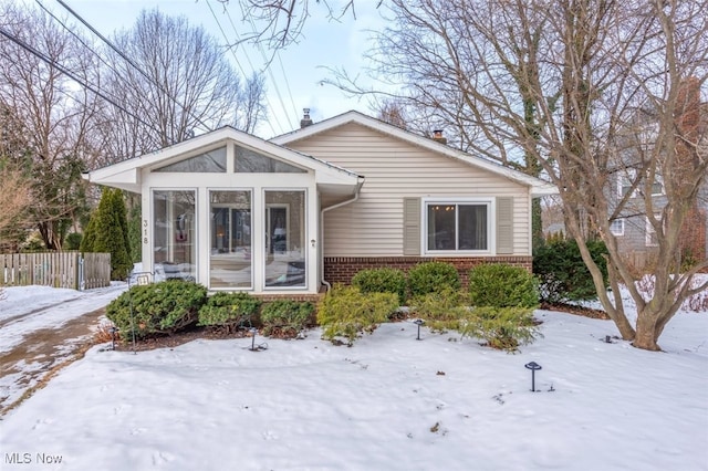 view of front of house with a sunroom