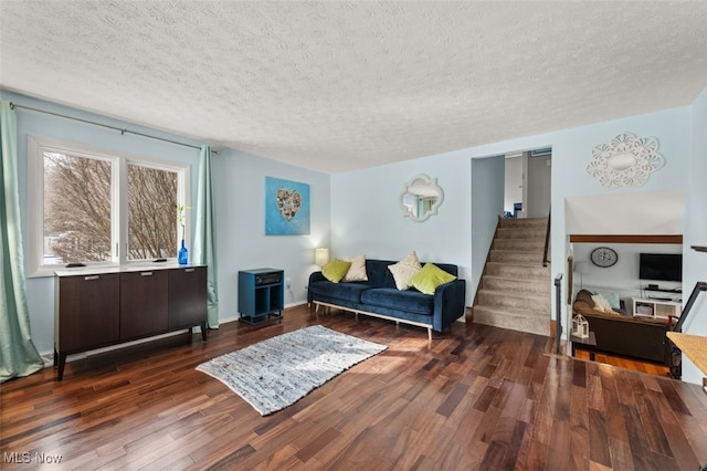 living room featuring dark hardwood / wood-style floors and a textured ceiling