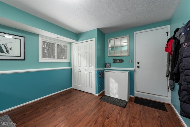 entrance foyer featuring dark hardwood / wood-style floors and a textured ceiling