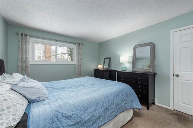 carpeted bedroom featuring a textured ceiling