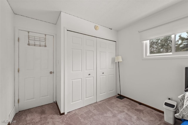 carpeted bedroom with a closet