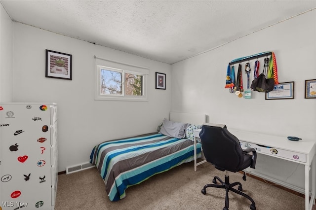 bedroom with carpet and a textured ceiling