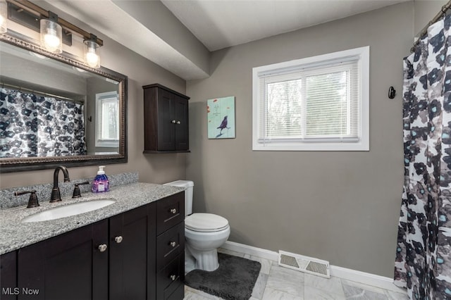 bathroom featuring vanity and toilet