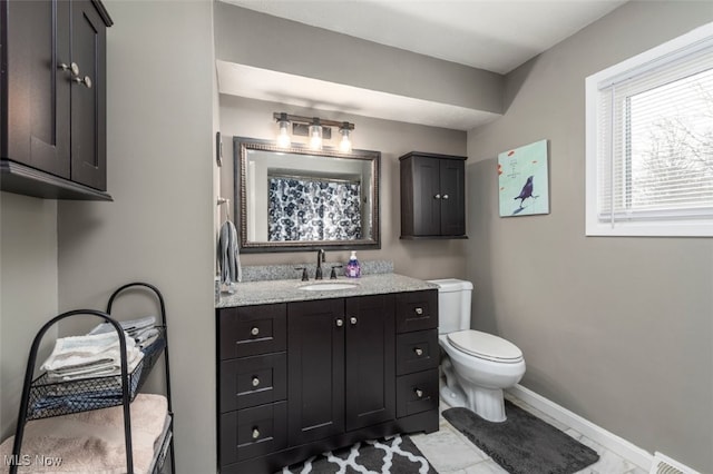 bathroom with vanity, tile patterned floors, and toilet