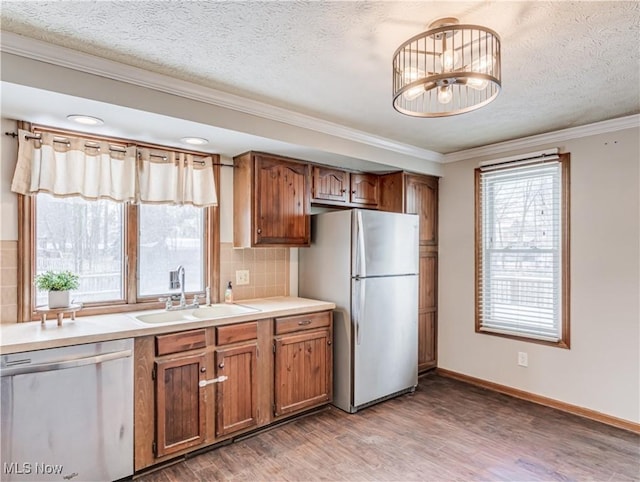 kitchen featuring sink, decorative backsplash, a textured ceiling, and appliances with stainless steel finishes