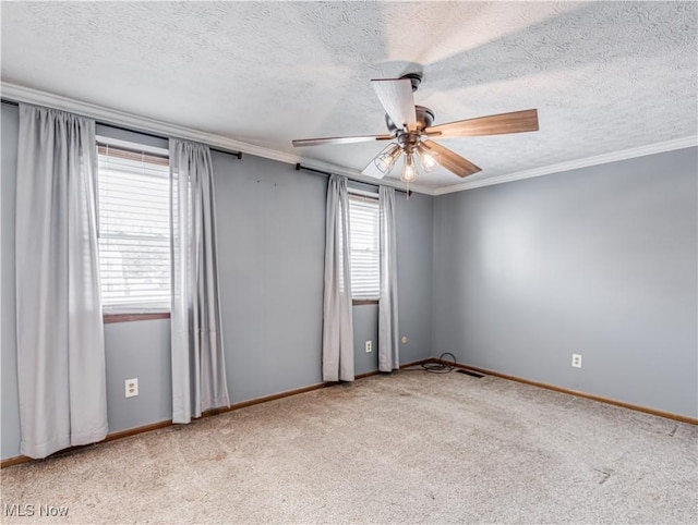 empty room featuring ornamental molding, a healthy amount of sunlight, light carpet, and ceiling fan