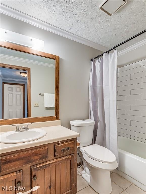 full bathroom with crown molding, shower / bath combo, tile patterned flooring, vanity, and a textured ceiling