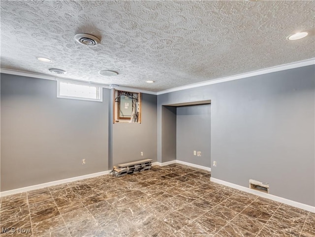 basement featuring ornamental molding and a textured ceiling