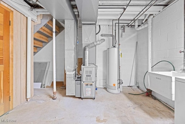 utility room with heating unit and water heater