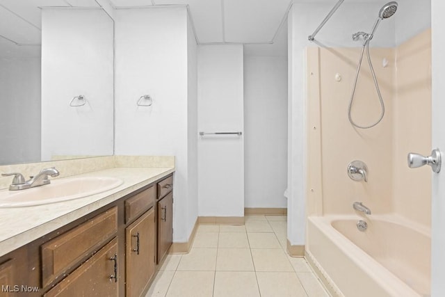 bathroom with tile patterned flooring, vanity, bathtub / shower combination, and a drop ceiling