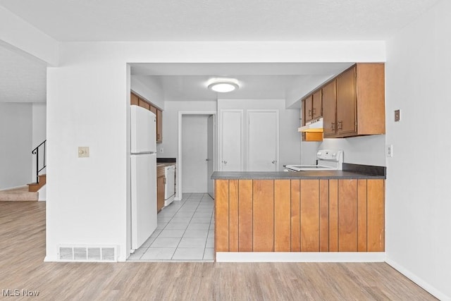 kitchen with light tile patterned floors and white appliances