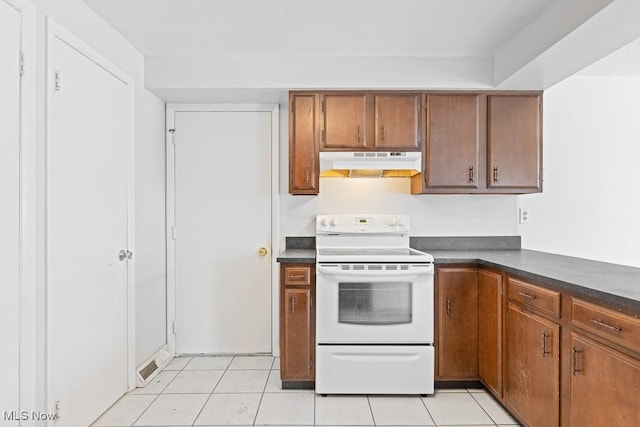 kitchen featuring light tile patterned floors and electric range