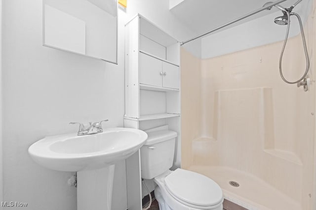 bathroom with toilet and walk in shower