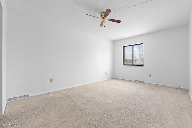 empty room featuring light carpet and ceiling fan