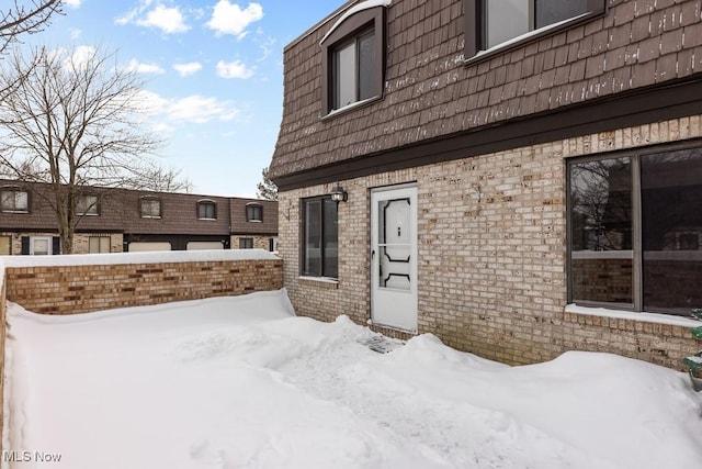 view of snow covered property entrance