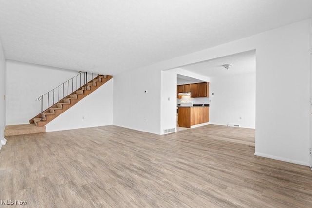 unfurnished living room featuring hardwood / wood-style floors