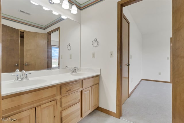 bathroom featuring ornamental molding and vanity