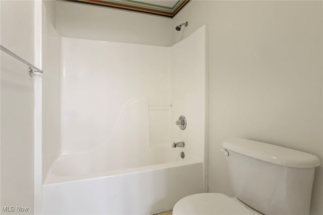 bathroom featuring washtub / shower combination and toilet