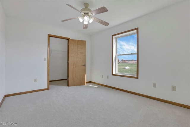 unfurnished bedroom featuring ceiling fan, light colored carpet, and a closet