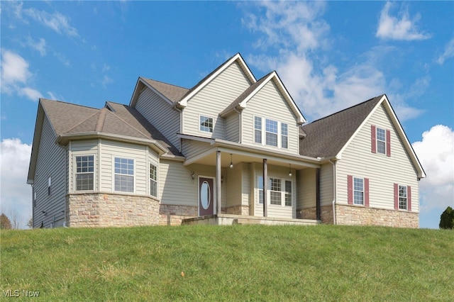 view of front facade with covered porch and a front lawn