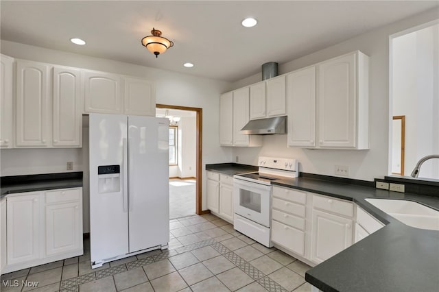 kitchen with light tile patterned flooring, sink, white cabinets, and white appliances