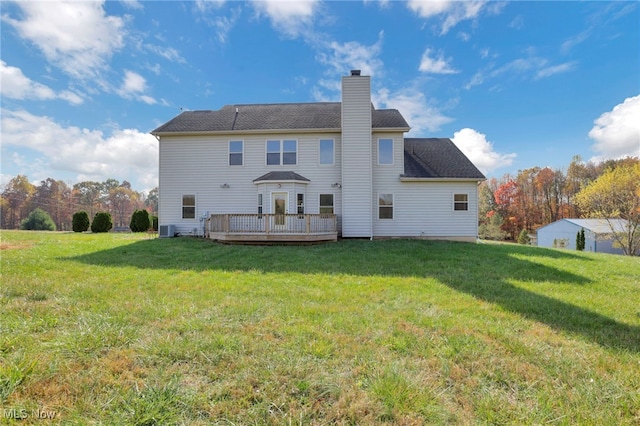 rear view of property featuring a wooden deck and a yard