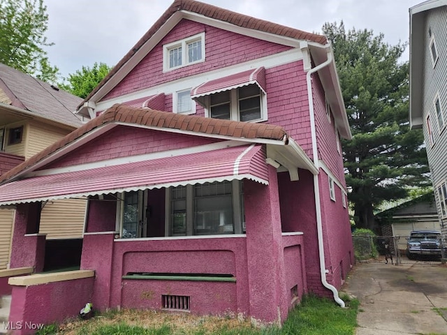 view of front of home with a tile roof and stucco siding