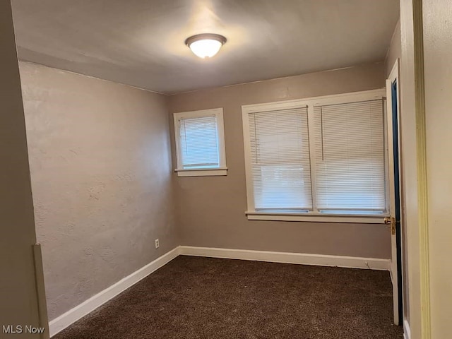 empty room with dark carpet