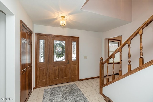 foyer entrance with light tile patterned floors