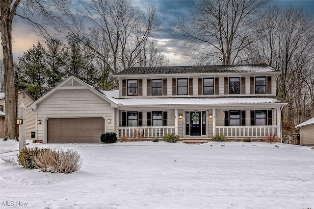 colonial-style house featuring a garage and a porch