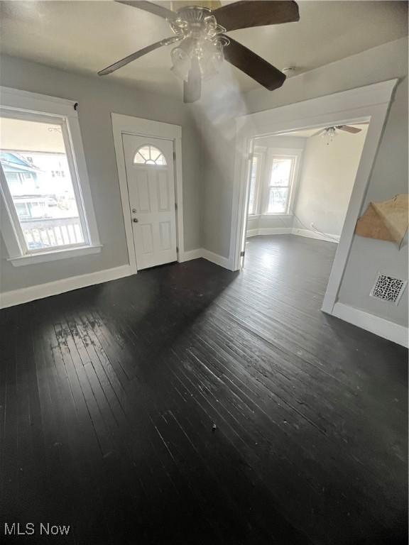 foyer with dark hardwood / wood-style floors and ceiling fan