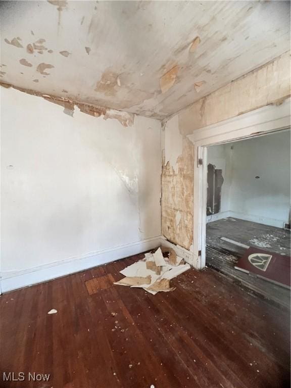 empty room with dark wood-type flooring