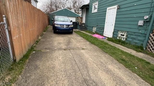 view of side of home with a garage and an outdoor structure