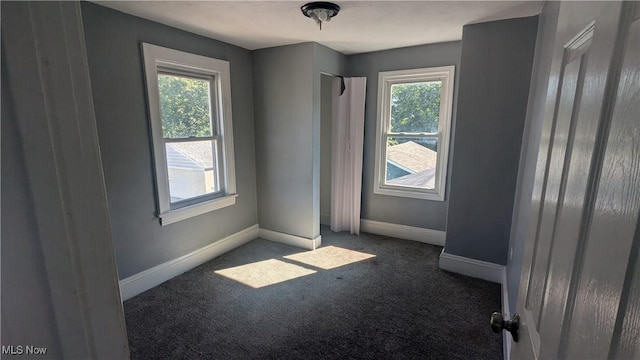 carpeted spare room with a healthy amount of sunlight