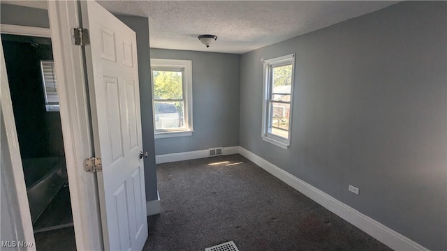 spare room with a textured ceiling