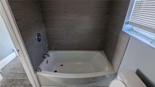 bathroom featuring a bathing tub and toilet