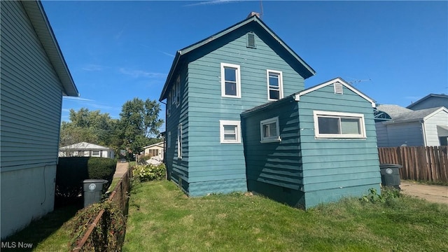 rear view of property with a yard